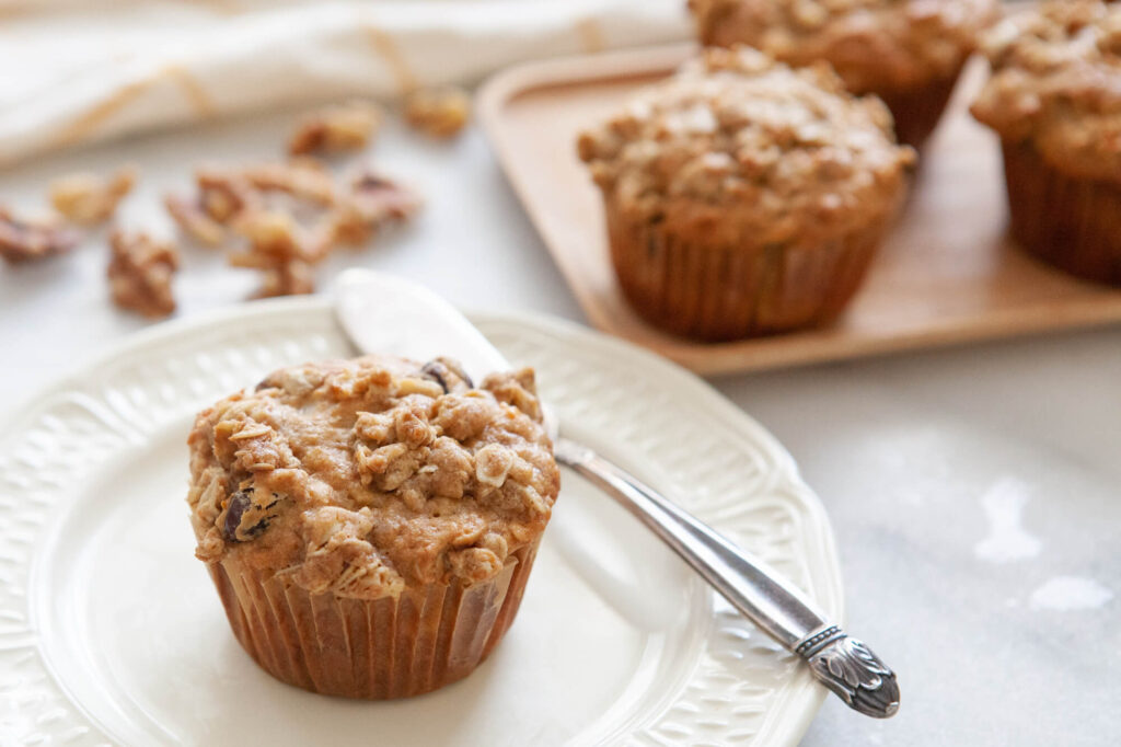 carrot cake muffin made with Kate's Butter on plate with butter knife