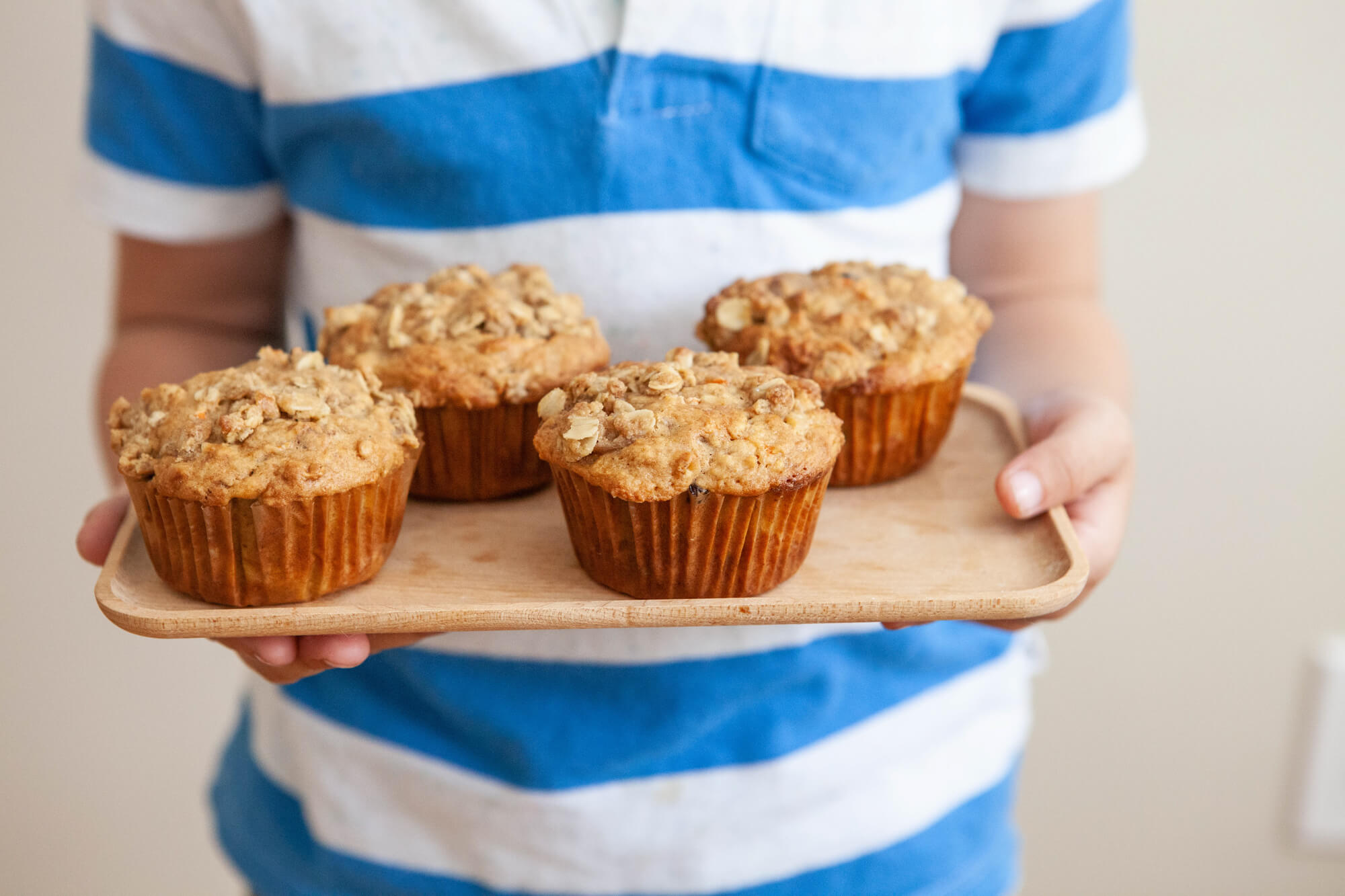 carrot cake muffins made with homemade butter on wooden platter