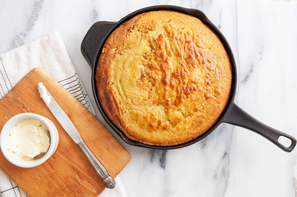 cornbread baked in a skillet with homemade butter