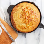 cornbread baked in a skillet with homemade butter