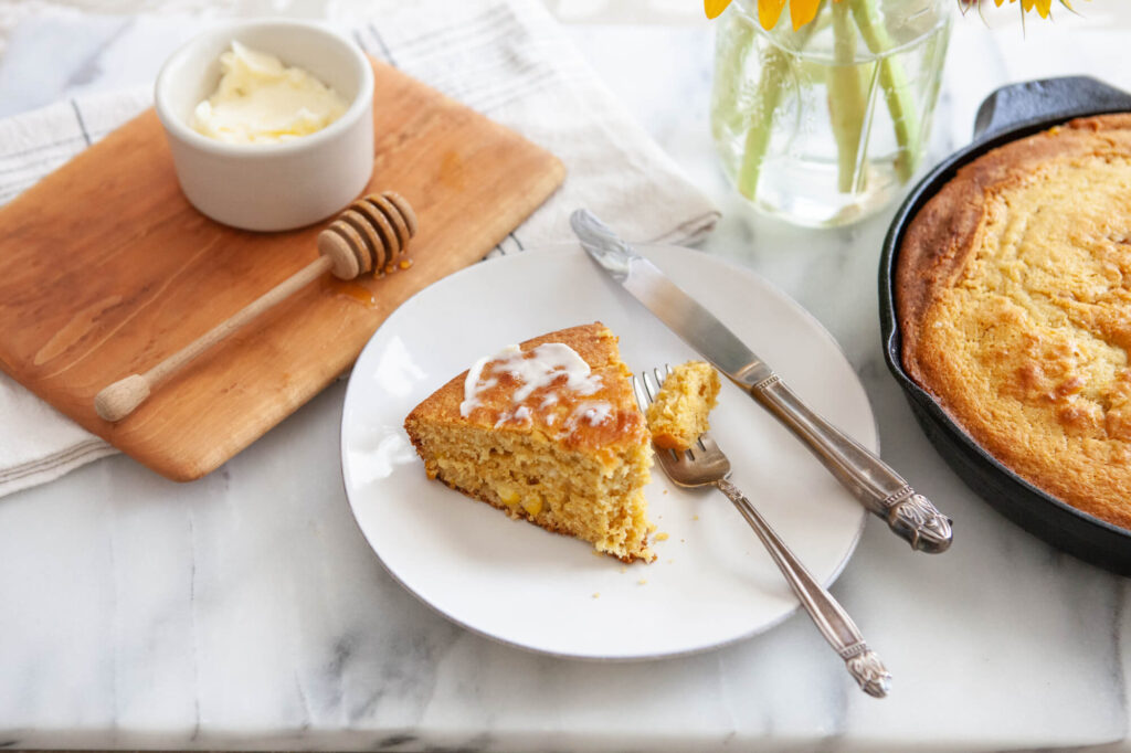 cornbread wedge with homemade butter spread on top