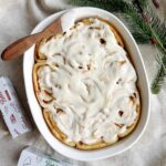 Serving dish full of Cinnamon rolls covered in icing